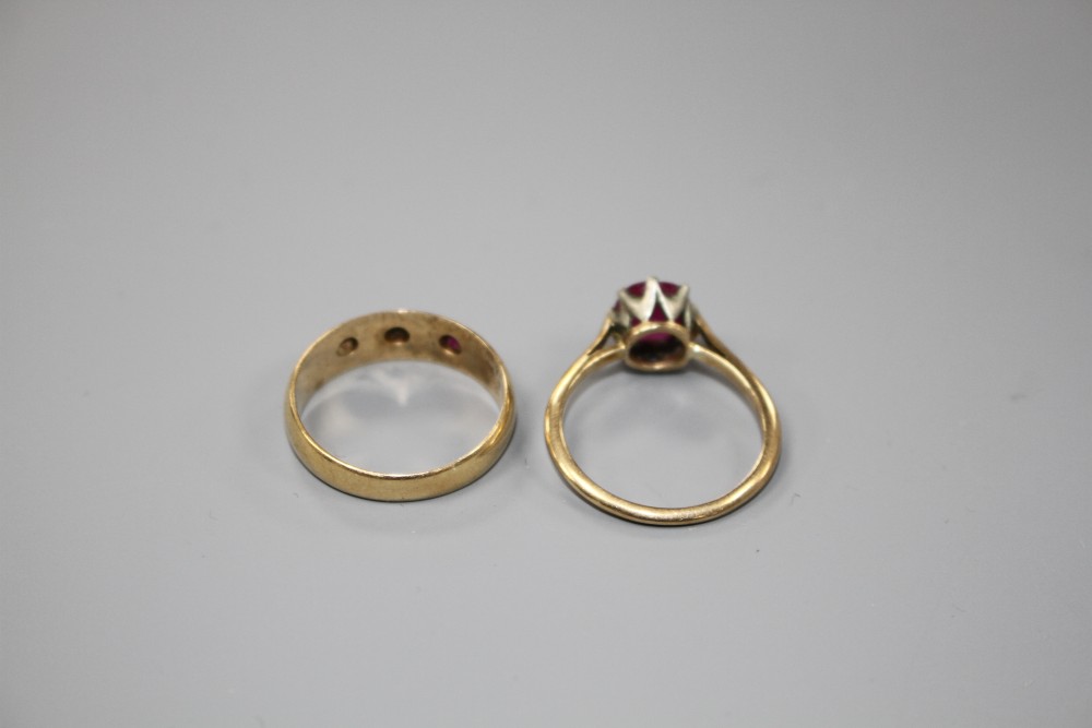 An early 20th century 18ct gold and gypsy set ruby and diamond three stone ring and one other ring.